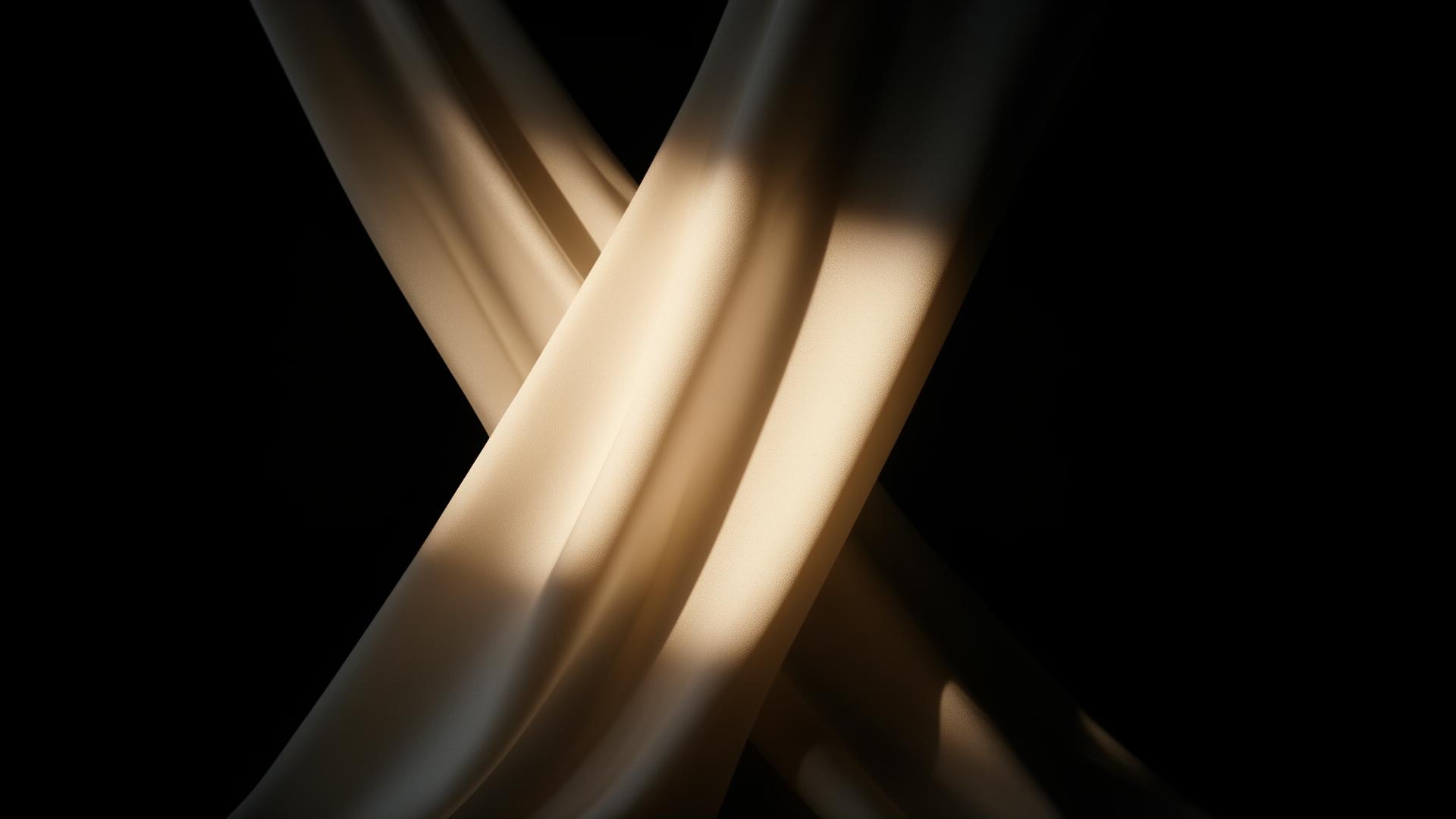 Liquid folds of ivory silk catching warm light against deep shadow
